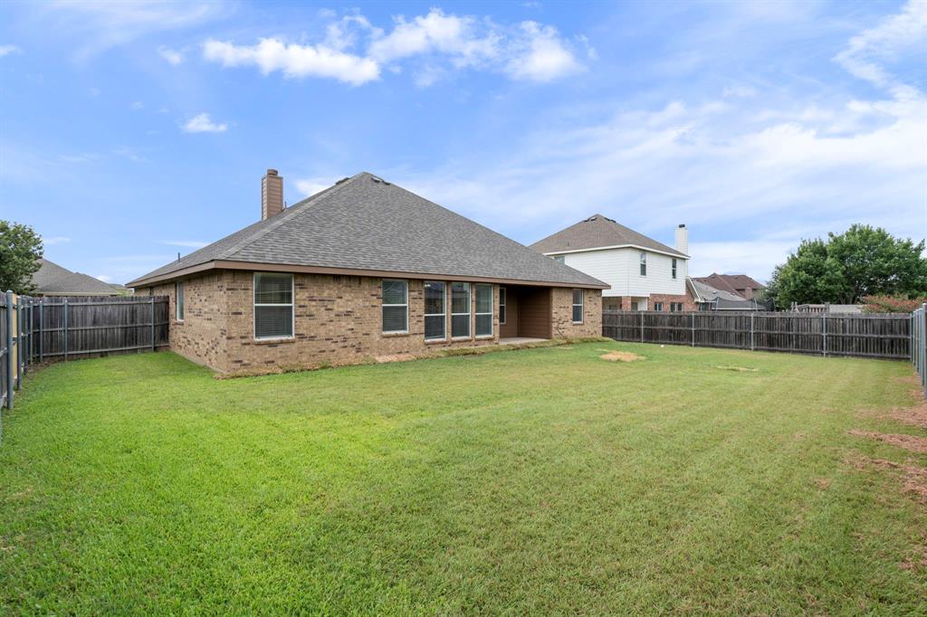 613 Hummingbird Trail Crowley, TX 76036 - Photo 37 of 37 a front view of a house with a garden