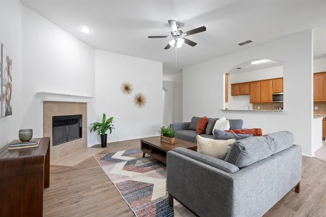 a living room with furniture and a fireplace