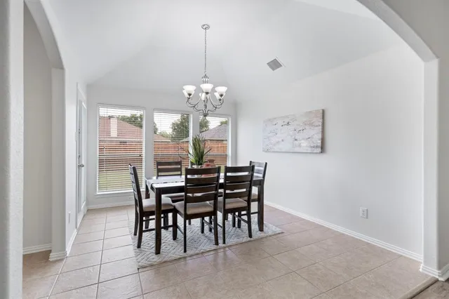a view of a dining room with furniture and window