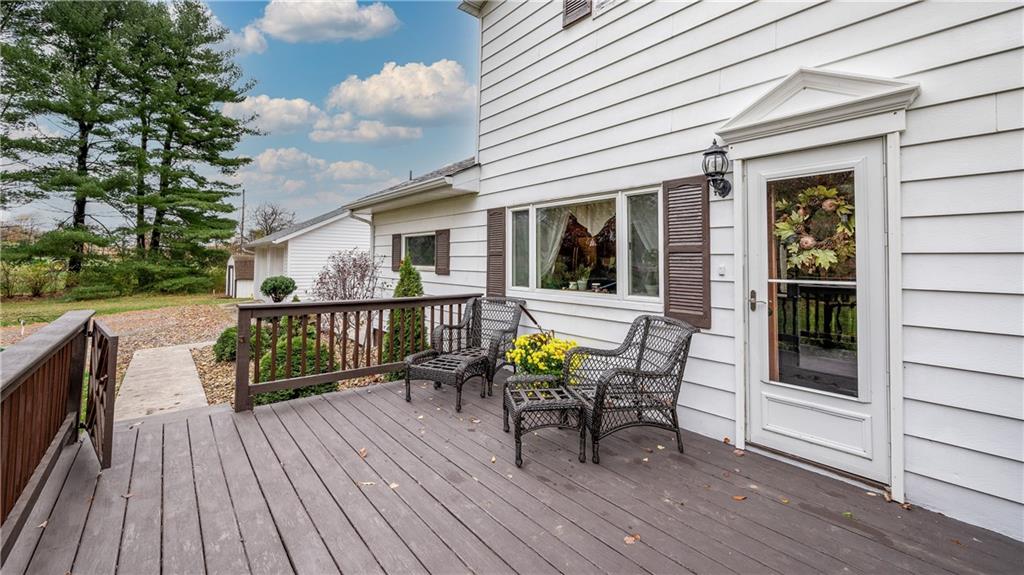 Large front deck welcomes guests and offers a place to relax