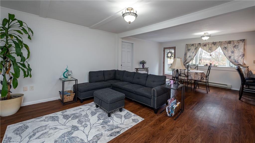 221 Kelly Road Slippery Rock, PA 16057 - Photo 10 of 25 Comfortable living room is just around the corner from the kitchen - large windows and neutral decor bring in the light