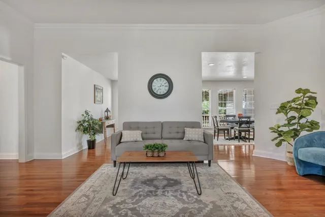 a living room with furniture and wooden floor