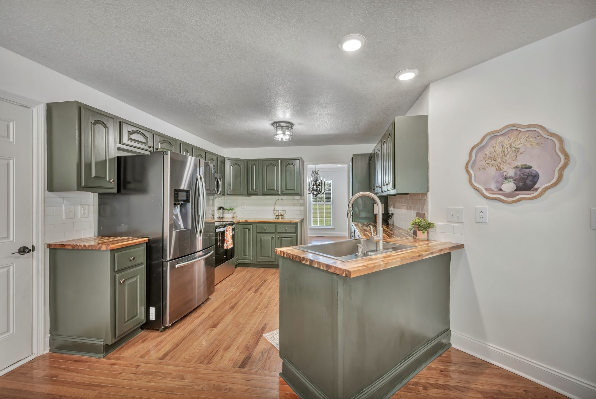 2044 Old Blacktop Road McEwen, TN 37101 - Photo 26 of 45 a living room with stainless steel appliances kitchen island granite countertop a refrigerator a stove top oven a sink and dishwasher