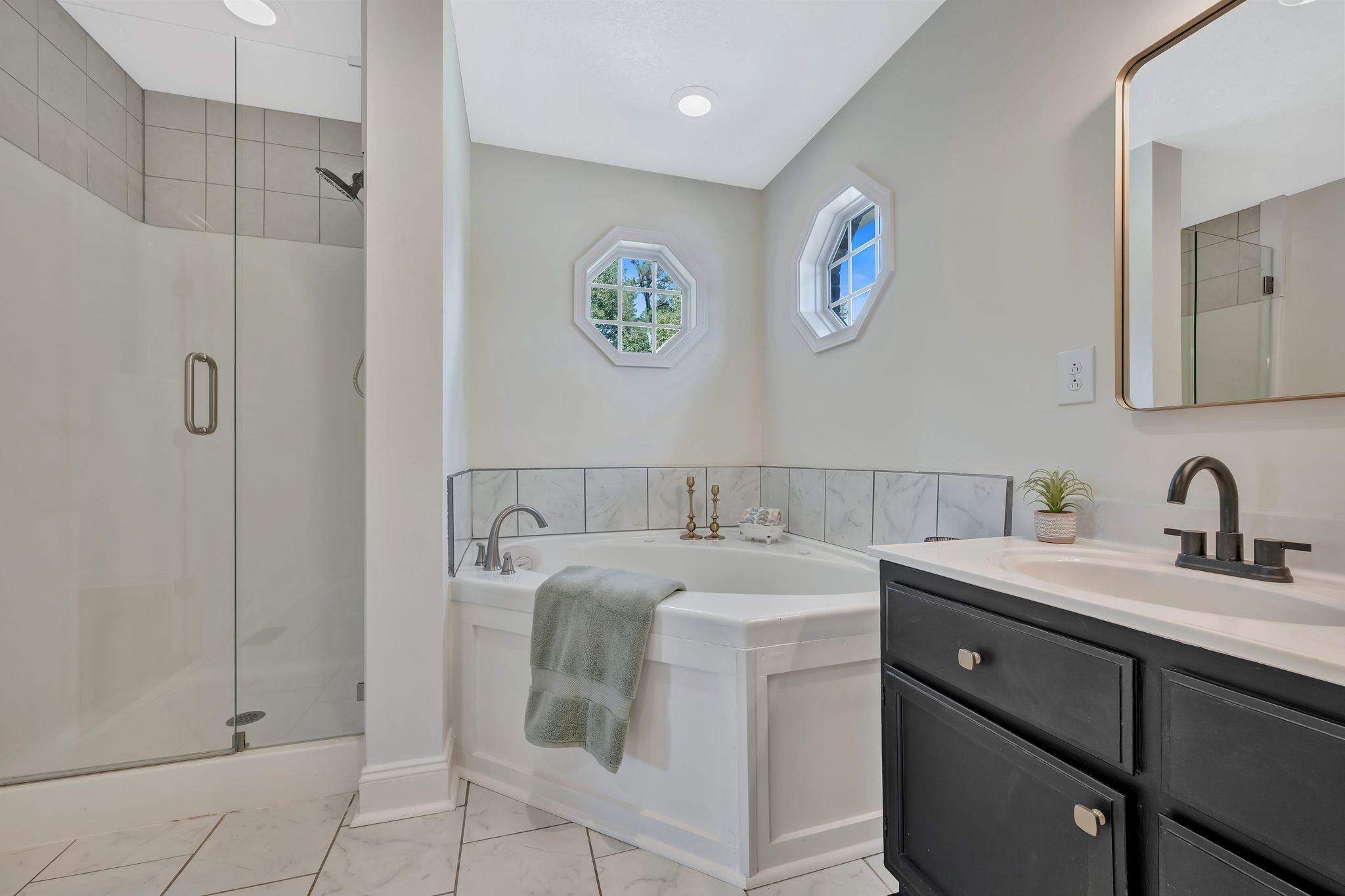 2044 Old Blacktop Road McEwen, TN 37101 - Photo 33 of 45 a bathroom with a granite countertop sink a mirror and a shower