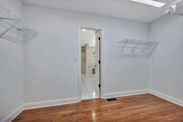 a spacious bedroom with a bed and a window