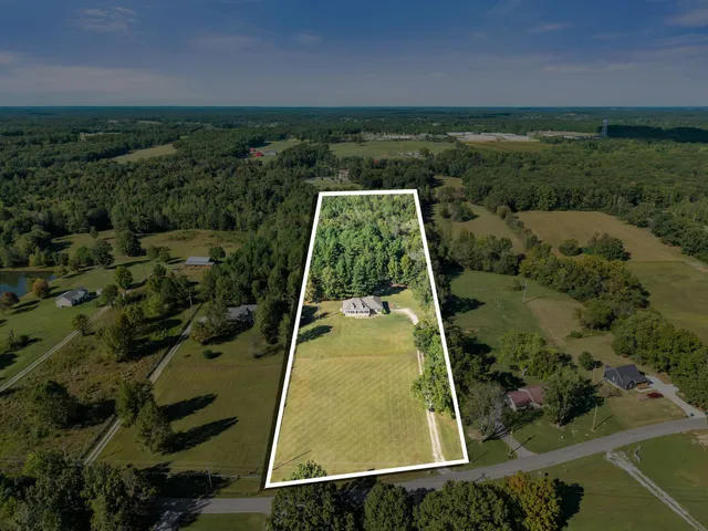 an aerial view of residential house with outdoor space