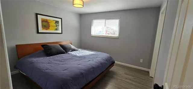 a bed sitting in a bedroom next to a window