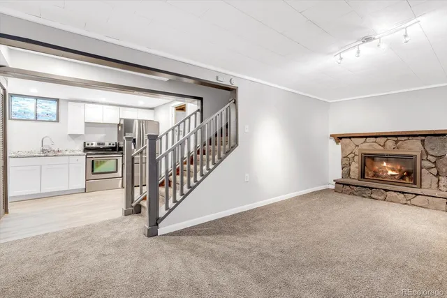 a view of an empty room with a fireplace and a window