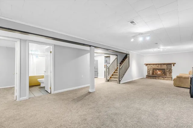 a view of a livingroom with a staircase and a fireplace