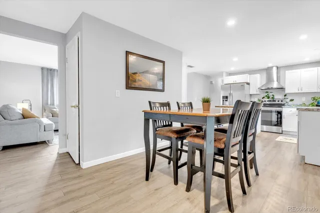 a view of a dining room with furniture and wooden floor