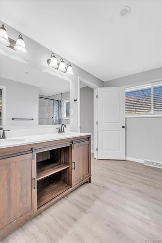 a spacious bathroom with a double vanity sink and a mirror