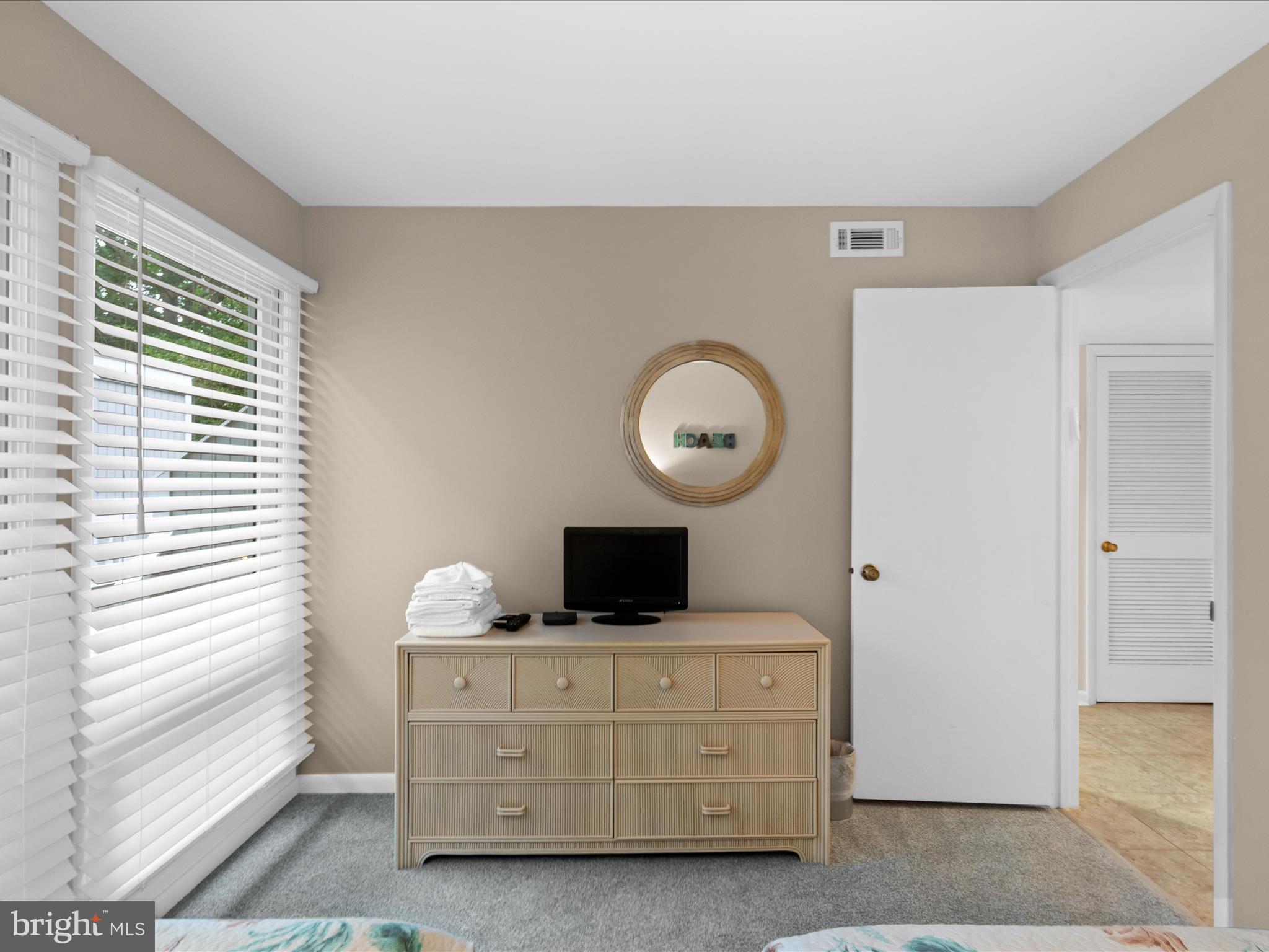 39346 Racquet Lane, Unit 8504 Bethany Beach, DE 19930 - Photo 23 of 40 a bedroom with a bed and a window