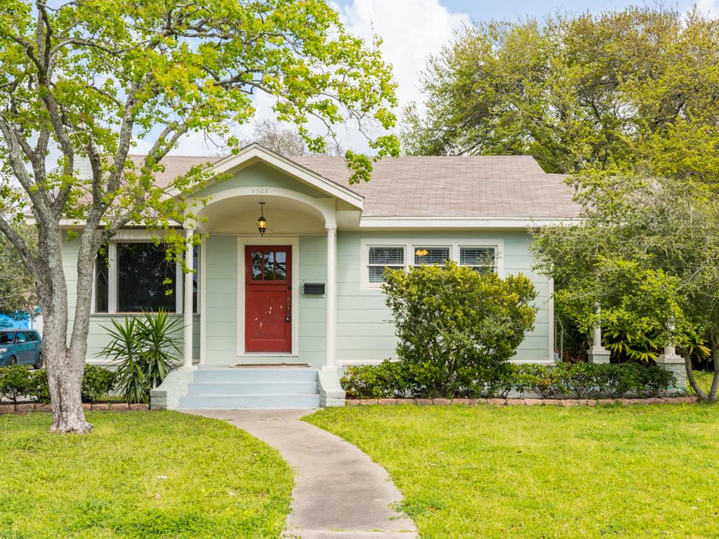 4528 Avenue R 1/2 Galveston, TX 77551 - Photo 1 of 22 a front view of a house with garden