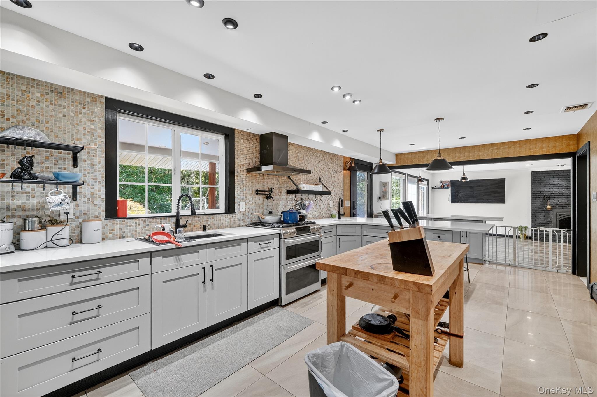 306 South Pascack Road Nanuet, NY 10954 - Photo 17 of 48 Kitchen with open shelves, range with two ovens, decorative backsplash, a peninsula, and wall chimney range hood