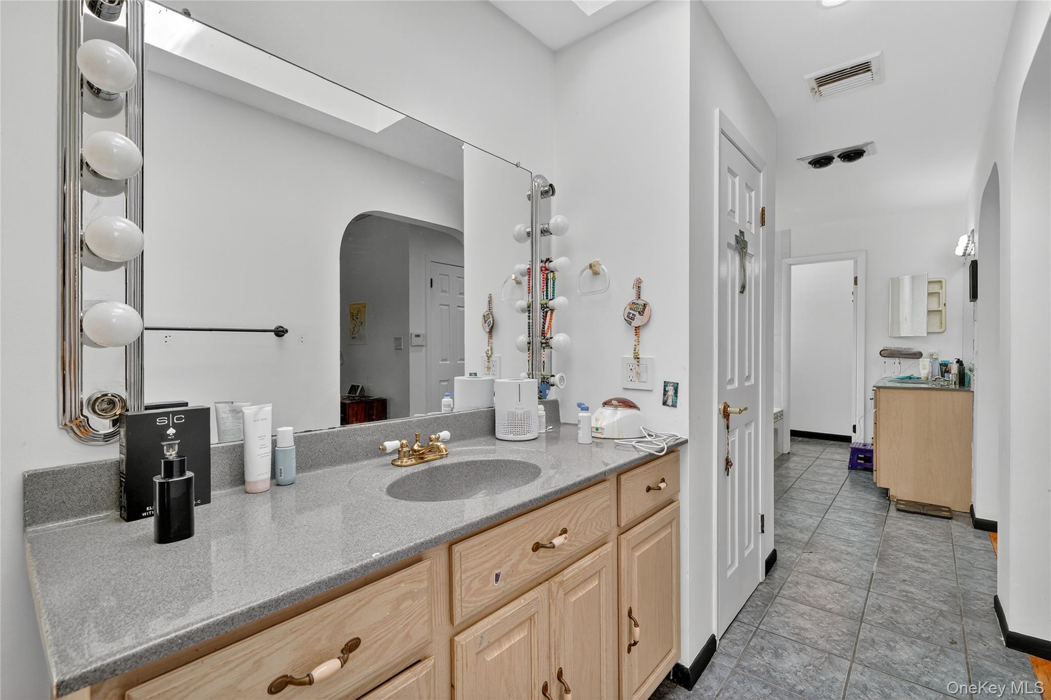 306 South Pascack Road Nanuet, NY 10954 - Photo 31 of 48 Bathroom with vanity, a skylight, and light tile patterned floors