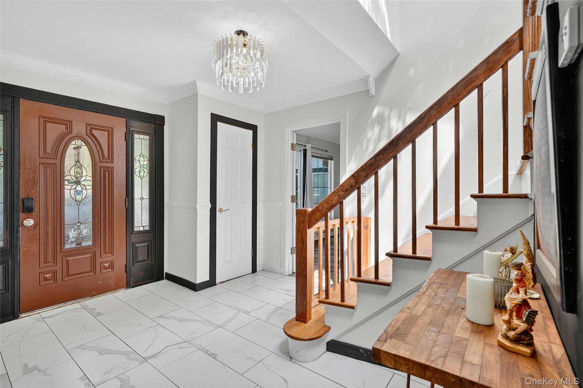 306 South Pascack Road Nanuet, NY 10954 - Photo 5 of 48 Foyer entrance featuring marble finish flooring, crown molding, a chandelier, and stairs