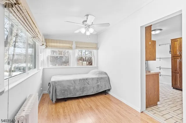 a bedroom with a bed and a large window with outer view