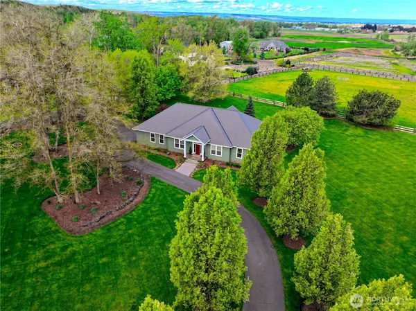 an aerial view of a house with garden space and outdoor seating