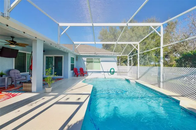 a living room with patio furniture and a potted plant