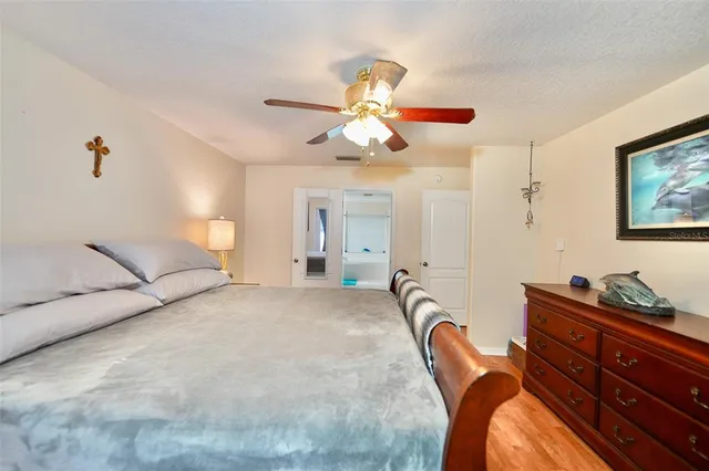 a bedroom with a bed and a chandelier