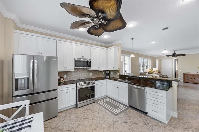 a kitchen with stainless steel appliances a stove a sink and a refrigerator