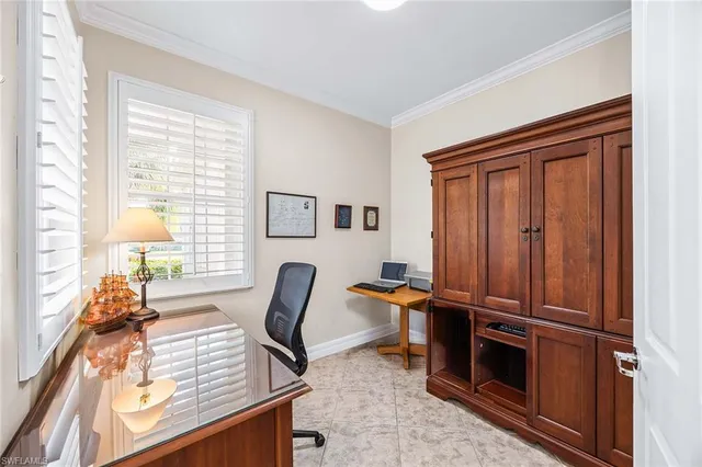 a view of a workspace with furniture and a window