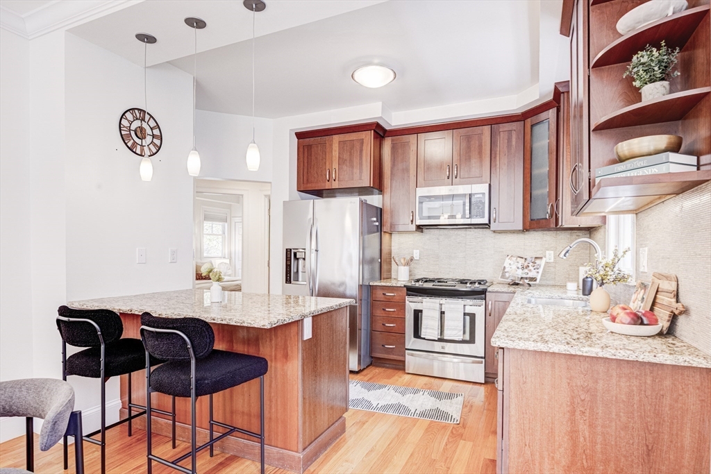 19 Harris Street, Unit 2 Brookline, MA 02446 - Photo 11 of 31 a kitchen with granite countertop a sink cabinets and window