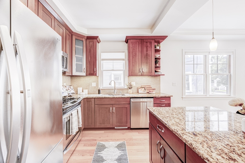 19 Harris Street, Unit 2 Brookline, MA 02446 - Photo 14 of 31 a kitchen with stainless steel appliances granite countertop a stove sink and cabinets