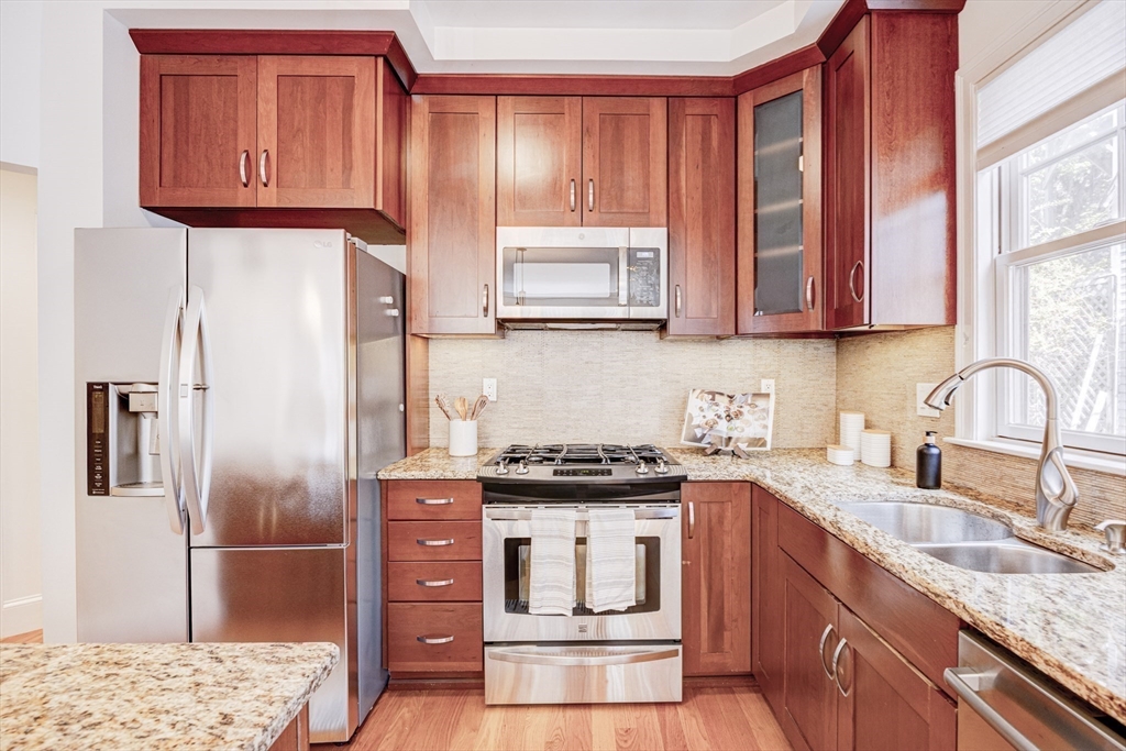 19 Harris Street, Unit 2 Brookline, MA 02446 - Photo 16 of 31 a kitchen with stainless steel appliances granite countertop a stove a sink and a refrigerator