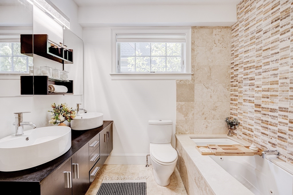 19 Harris Street, Unit 2 Brookline, MA 02446 - Photo 21 of 31 a bathroom with a sink toilet a mirror and shower