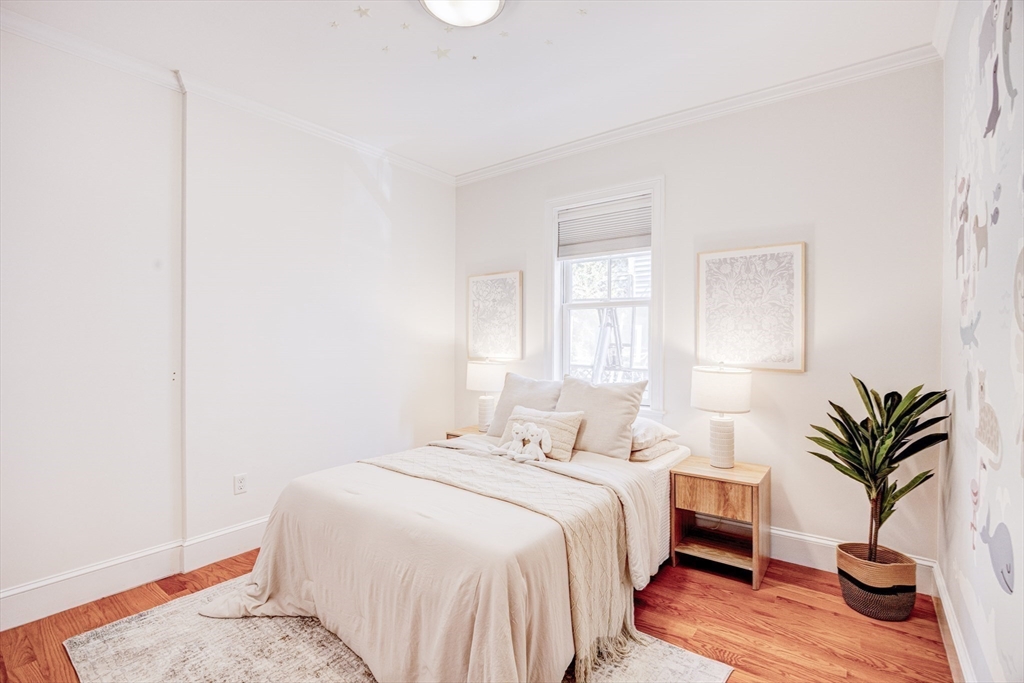 19 Harris Street, Unit 2 Brookline, MA 02446 - Photo 23 of 31 a bedroom with a bed and a potted plant