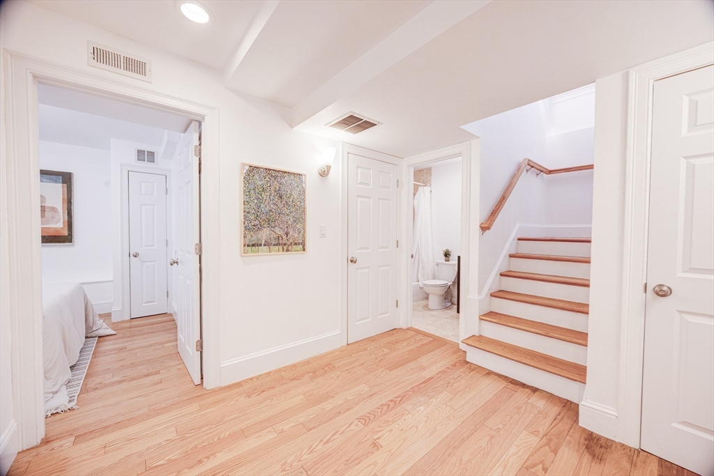 19 Harris Street, Unit 2 Brookline, MA 02446 - Photo 27 of 31 a view of a livingroom with wooden floor and stairs