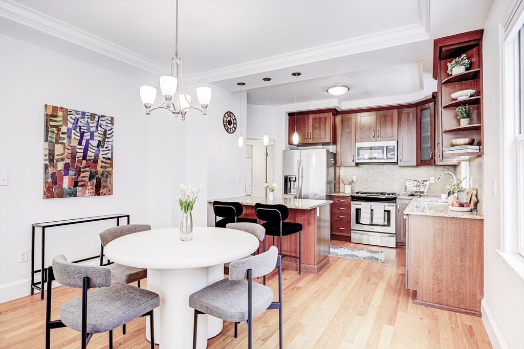 19 Harris Street, Unit 2 Brookline, MA 02446 - Photo 10 of 31 a view of kitchen with stainless steel appliances granite countertop a stove a sink a dining table and chairs