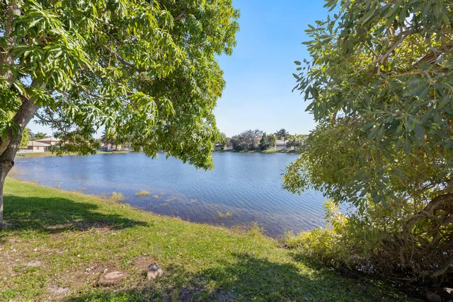 a view of staircase with railing and white walls