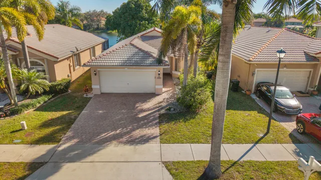 an aerial view of a house with a yard and sitting area