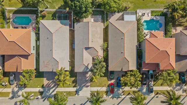 an aerial view of house with yard and lake view