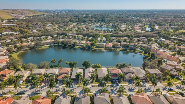 an aerial view of residential building with outdoor space lake and green space