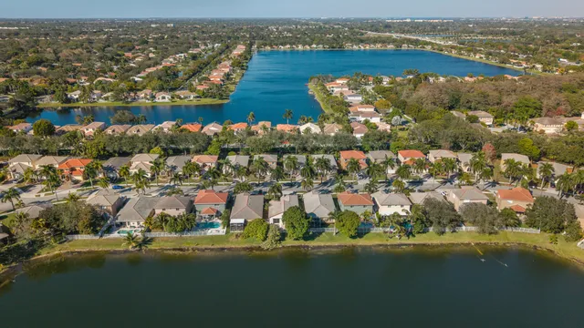 an aerial view of lake and residential houses with outdoor space
