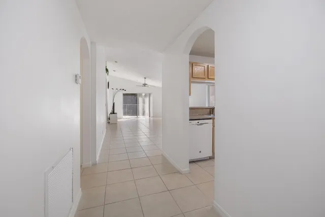a view of a hallway with windows and cabinet