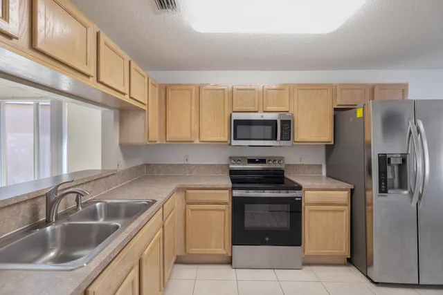 a kitchen with a sink stove and refrigerator