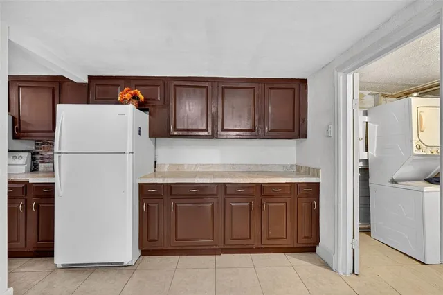 a bedroom with a bed and a potted plant