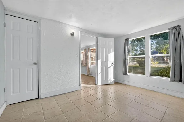 a view of a workspace with furniture and book shelf