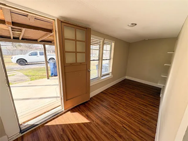 a view of front door and wooden floor