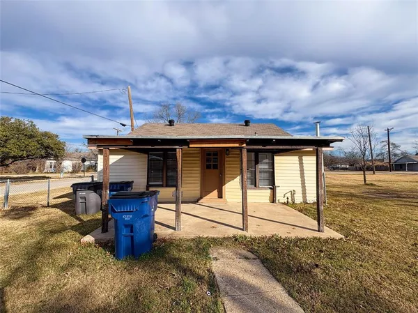 a view of a house with backyard space and wooden fence