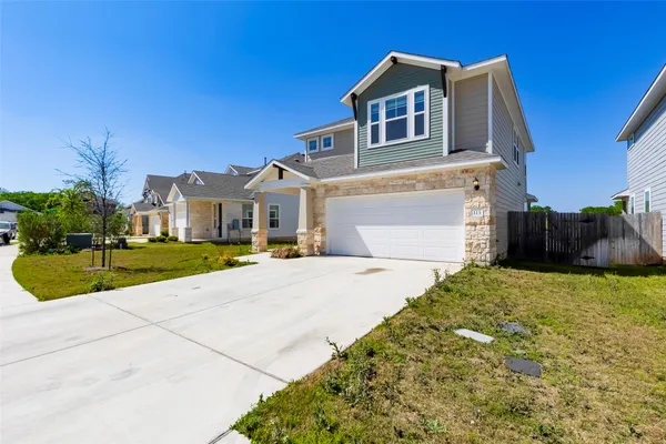 a front view of a house with a yard