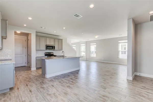 an empty room with windows and closet