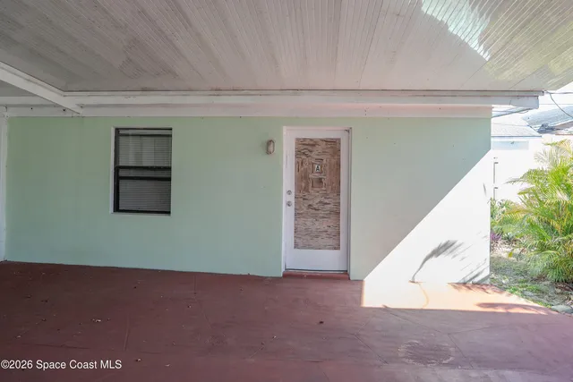 a view of a big room with entryway and stairs