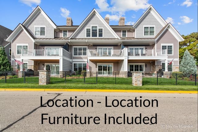 a front view of a house with garden swimming pool and outdoor seating