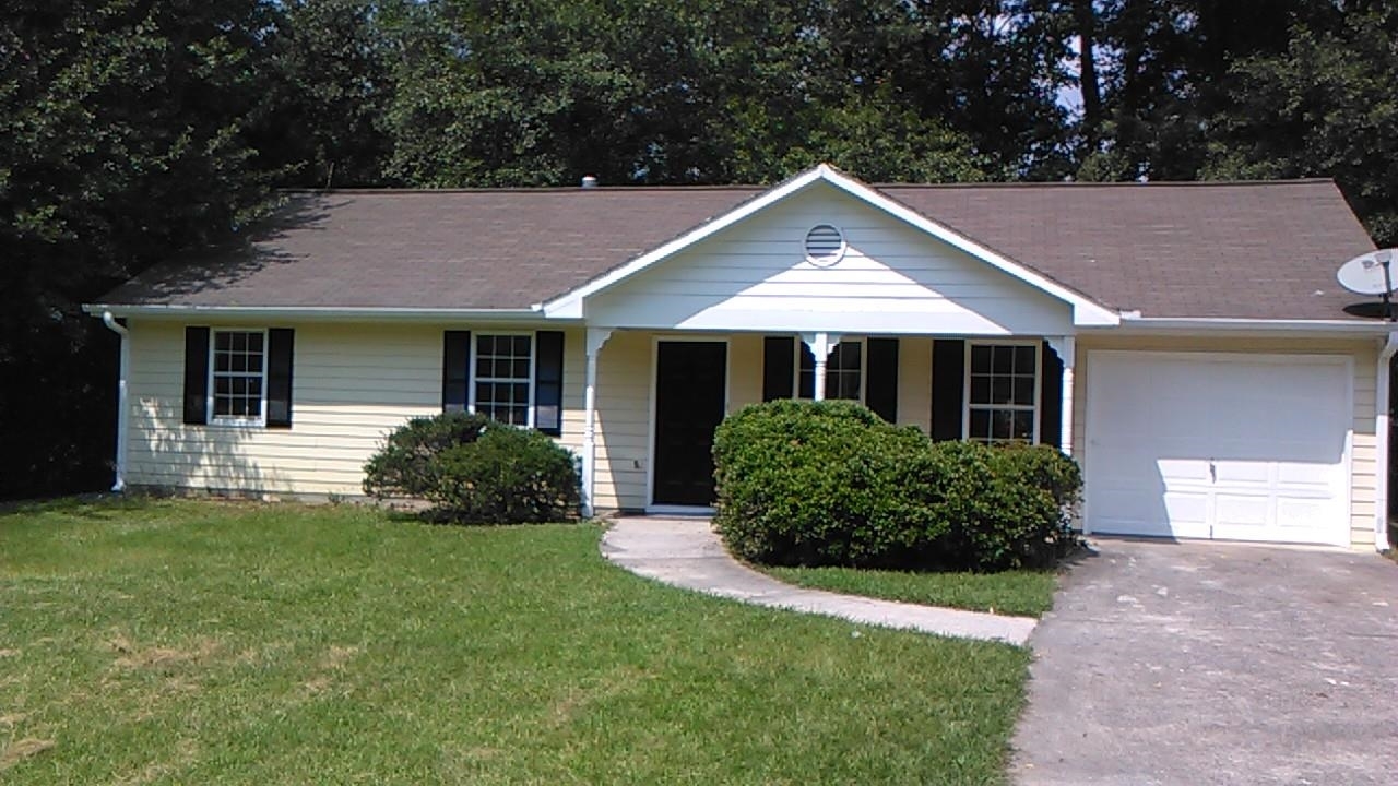 4473 Frank Aiken Road Powder Springs, GA 30127 - Photo 1 of 1 a front view of a house with a yard and garage