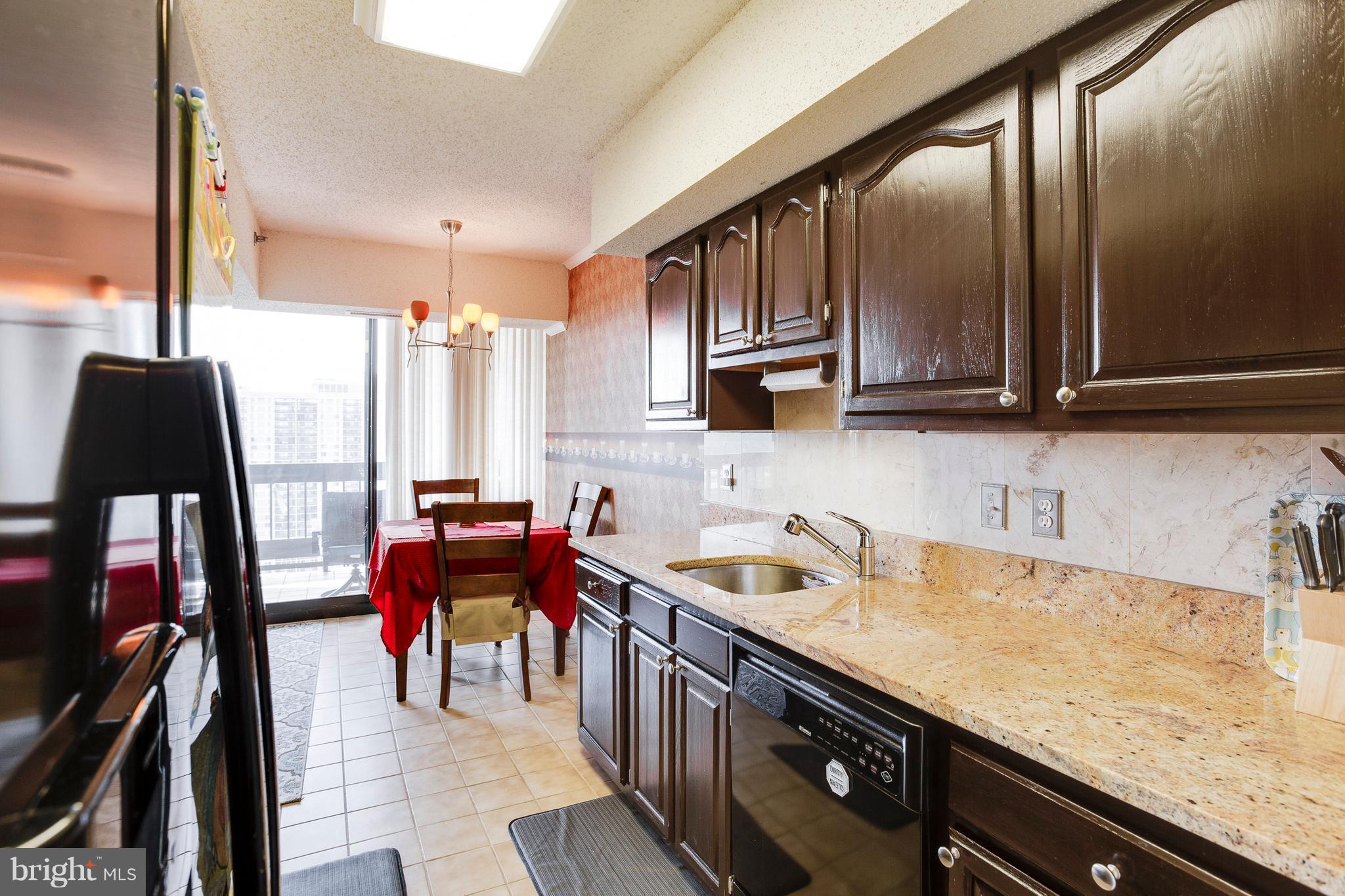 5505 Seminary Road, Unit 2211N Falls Church, VA 22041 - Photo 12 of 30 a kitchen with stainless steel appliances granite countertop sink stove top oven and cabinets